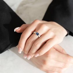 Photo of worn Solitaire ring surrounded by 1.324ct Blue Sapphire and Diamonds