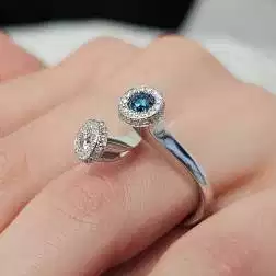 Photo of worn White Diamonds and Blue Diamond Steli Ring in White Gold