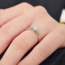 Photo of worn Trilogy platinum ring with central diamond GIA 0.30 ct.