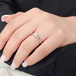 Photo of worn Trilogy platinum ring with central diamond GIA 0.30 ct.
