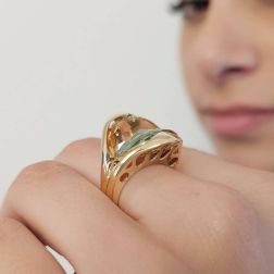 Photo of worn Design Ring "Mid-Summer Dream" with yellow and blue Topaz in 18kt yellow gold