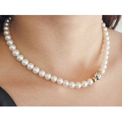 Photo of worn Akoya Pearl Necklace with Sphere Clasp and 9 Emeralds
