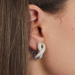 Photo of worn Infinito pavé earrings with 230 diamonds in white gold