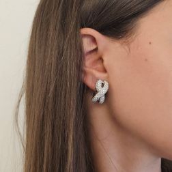Photo of worn Infinito pavé earrings with 230 diamonds in white gold