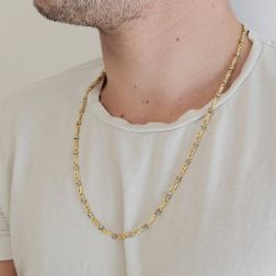Photo of worn 60cm Tubular Partridge Eye necklace in alternate Yellow Gold with 2 beads in White