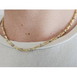 Photo of worn 45cm tubular necklace with round striped partridge eye in yellow gold alternating with 2 white eyelets