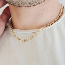 Photo of worn 45cm tubular necklace with round striped partridge eye in yellow gold alternating with 2 white eyelets