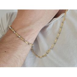 Photo of worn Tubular bracelet with round striped partridge eye in yellow gold alternating with 2 white eyelets