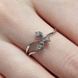 photo of worn three bands Trilogy Flower ring in White Gold and Diamonds