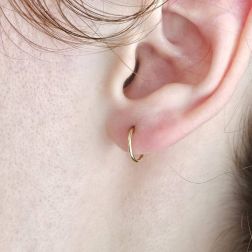 Photo of worn Hoops circles 1cm x 1mm in yellow gold