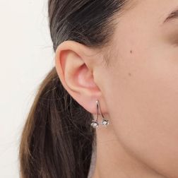 Photo of worn Double Flowers earrings with diamonds