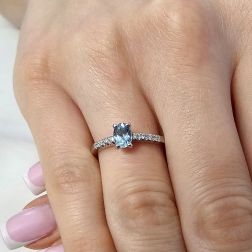 Photo of worn Oval Aquamarine Solitaire Ring with 8 Diamonds in White Gold