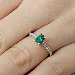 Photo of worn Oval Emerald Solitaire Ring with 8 Diamonds in White Gold