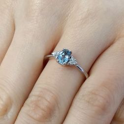 Photo of worn 6x4mm Oval Aquamarine Solitaire Ring with 6 Diamonds in White Gold