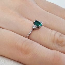 Anello Solitario Smeraldo Ovale 6x4mm e 6 Diamanti in Oro Bianco foto indossata
