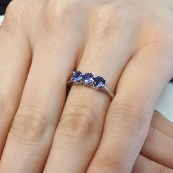 Photo of worn 4mm Tanzanite Trilogy Cruise Ring in White Gold
