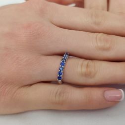 Photo of worn Veretta Ring with 7 Blue Sapphires Suspended in White Gold