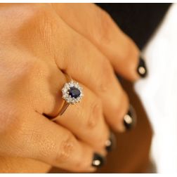 Photo of worn 5x4 Oval Blue Sapphire Solitaire Ring with 10 Diamonds
