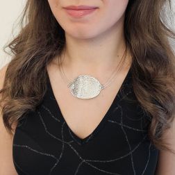 photo of worn Semi-rigid curved medallion necklace in white gold