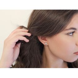 Photo of worn Solitary Studs earrings with round 6.20mm acquamarines in 18kt white gold