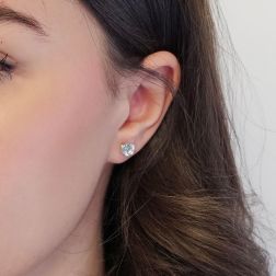 Photo of worn Solitary Studs earrings with round 6.20mm acquamarines in 18kt white gold