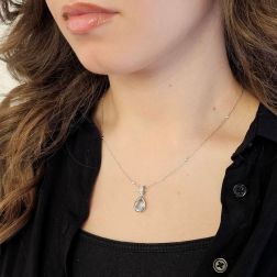 photo of worn Teardrop-shaped aquamarine pendant with 10 pavé-set diamonds