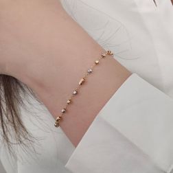 photo of worn Three-tone gold chain bracelet with faceted beads and charms