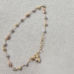 Three-tone gold chain bracelet with faceted beads and charms