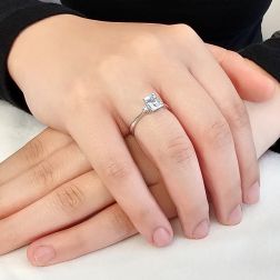 Photo of worn 7x5mm Octagonal Aquamarine Solitaire Ring with 2 Diamonds in White Gold