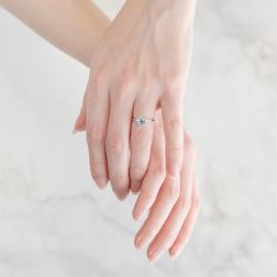 Photo of worn 7x5mm Oval Aquamarine Solitaire Ring with 2 Diamonds in White Gold