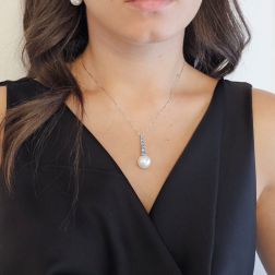 Photo of worn White Gold Tennis Necklace with Blue Diamonds and a Freshwater Pearl