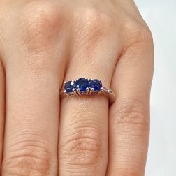 Photo of worn Blue Sapphires Graded Trilogy Ring in White Gold