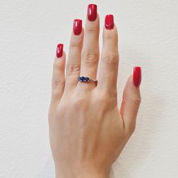 Photo of worn Blue Sapphires Graded Trilogy Ring in White Gold