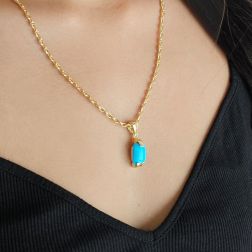 photo of worn Turquoise cabochon pendant in 18kt yellow gold