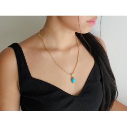 photo of worn Turquoise cabochon pendant in 18kt yellow gold