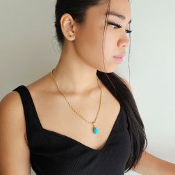 photo of worn Turquoise cabochon pendant in 18kt yellow gold
