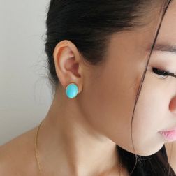 Photo of worn Oval Cabochon Turquoise Earrings in Yellow Gold