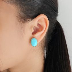 Photo of worn Oval Cabochon Turquoise Earrings in Yellow Gold