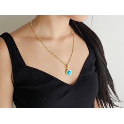 photo of worn Round pendant with a turquoise rhombus-shaped cabochon and 18kt yellow gold