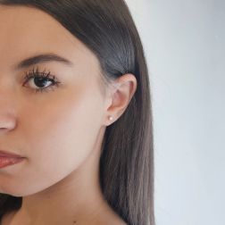 photo of worn Simple Point Light Solitaire Earrings with diamonds weighing 0.08/0.12ct each