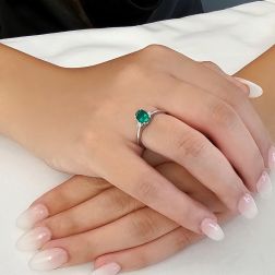 Anello Solitario Smeraldo ovale 7x5mm e 2 Diamanti in Oro Bianco foto indossata