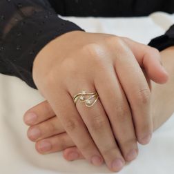Photo of worn Trilogy in Yellow Gold and Diamonds with three intertwined threads