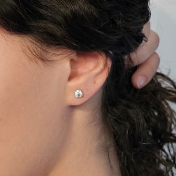 photo of worn, Solitaire earrings with 2 GIA certified Diamonds of 0.53ct G, VS2