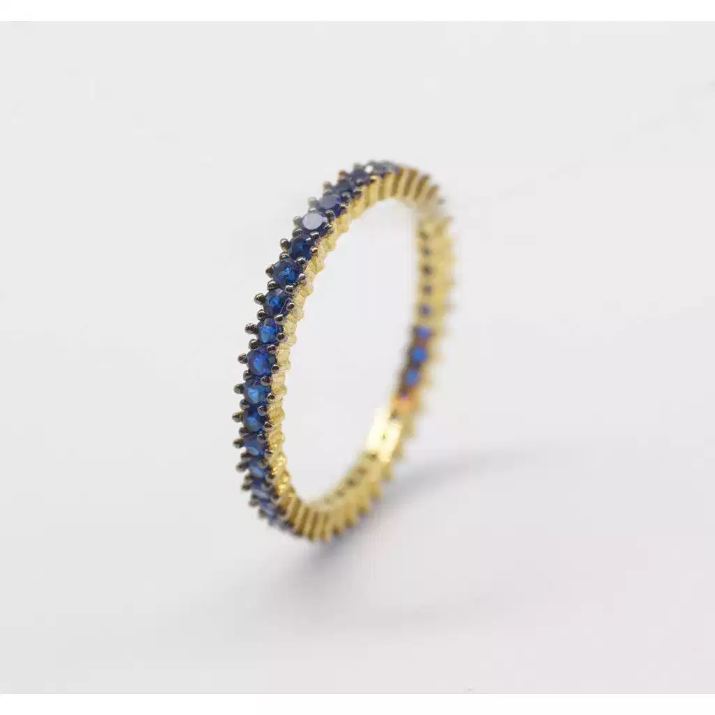 Eternity con zirconi blu e brunitura