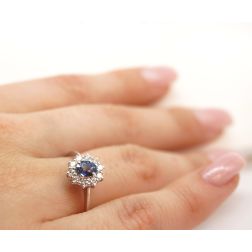 Photo of worn 5x4 Oval Blue Sapphire Solitaire Ring with 10 Diamonds