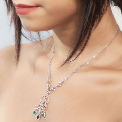 Photo of worn Oval Necklace with Emerald Diamonds and Blue Sapphire