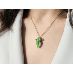 Photo of worn Blue Caterpillar on a bronze leaf Pendant