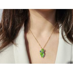 Photo of worn Blue Caterpillar on a bronze leaf Pendant
