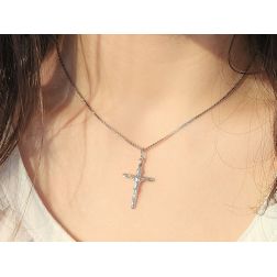 Photo of worn Tronchetto cross in white gold with Christ