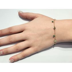 Bracelet with green stones and yellow gold discs
